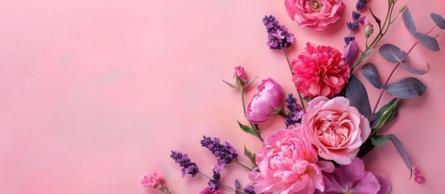 Top view image of pink and purple flowers arrangement on softcolored backdrop