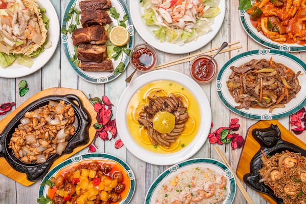 Top view image of popular Chinese dish set of orange duck tres delicias rice with prawns fried ribs sweet and sour pork beef with bamboo and mushroom shiitake