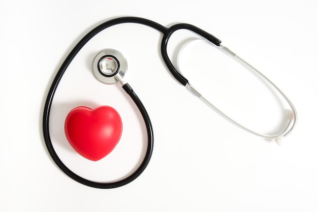 Top view image of red heart surrounded by black stethoscope on white background