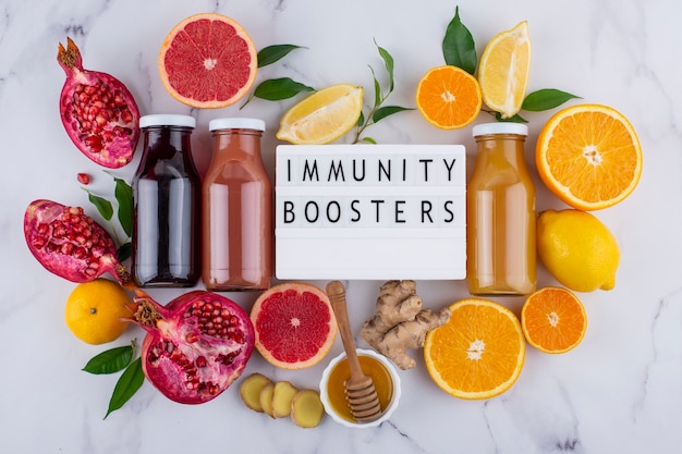 Photo top view of immunity boosting foods and juice with citrus and ginger