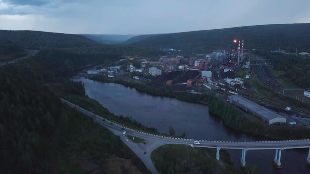 Top view of industrial city by river on summer evening clip beautiful landscape of industrial town