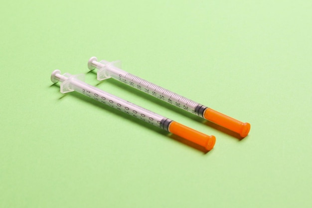 Top view of insulin syringes ready for injection on colorful background Diabetic concept with copy space