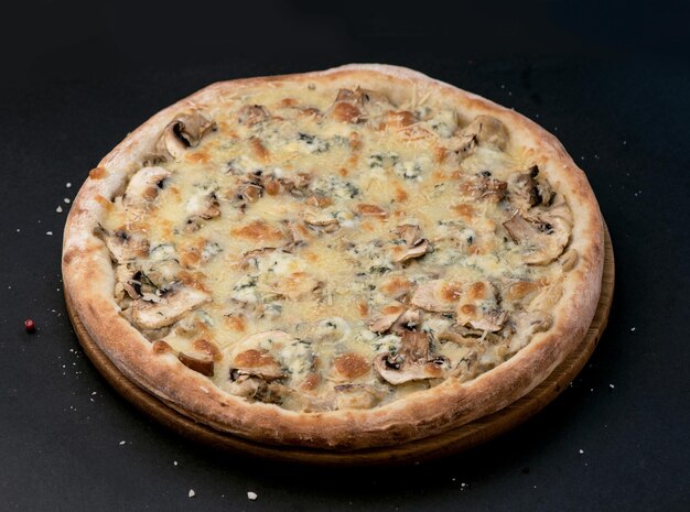 Top view of italian pizza with mushrooms and cheese on black background