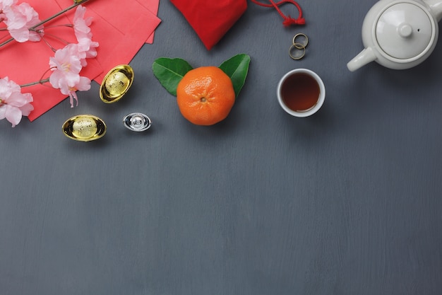 Top view of items for Chinese Happy New Year concept background.Different essential accessory on modern rustic table home decoration.Mix objects for the festival season.free space for creative design.