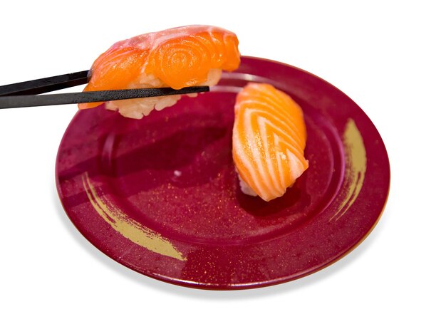 Top view of Japanese fresh salmon sushi with chopsticks focus selective