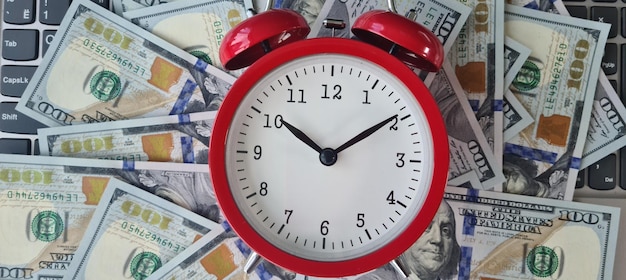 Top view of a keyboard with dollars and an alarm clock