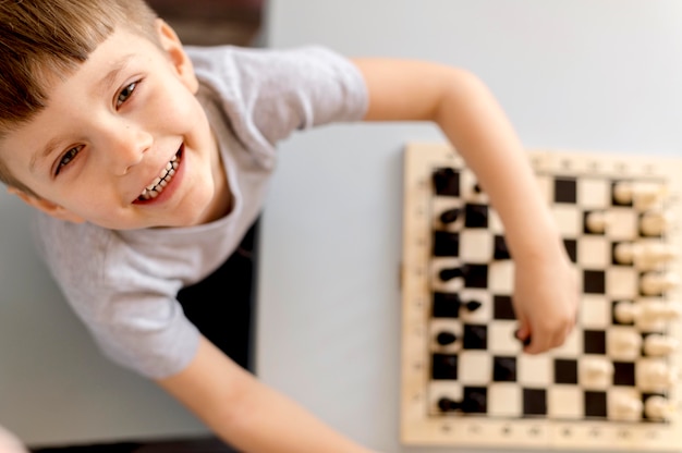 Top view kid with chess game