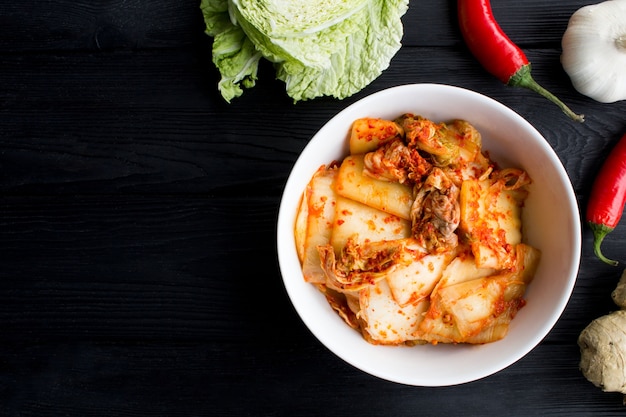 Top view of kimchi and ingredients on the black