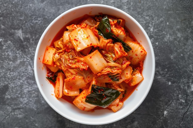 Photo top view of kimchi served in a white bowl