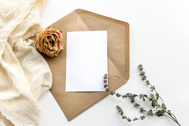 Top view of a kraft paper envelope and a white card Wedding women's fashion background