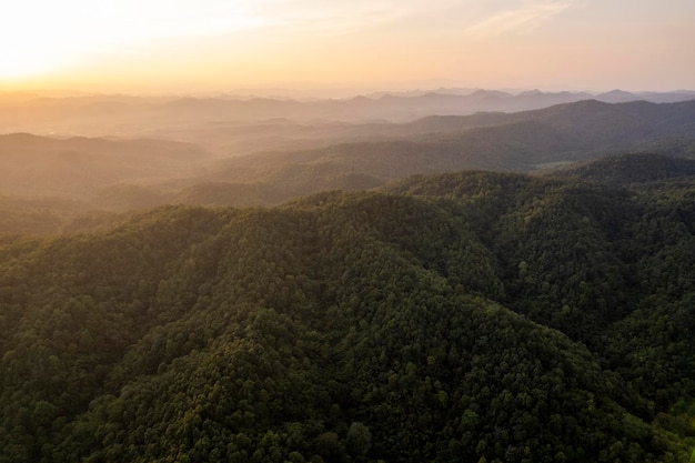 Top view Landscape of Morning Mist with Mountain Layer at north of Thailand mountain ridge and clouds in rural jungle bush forest