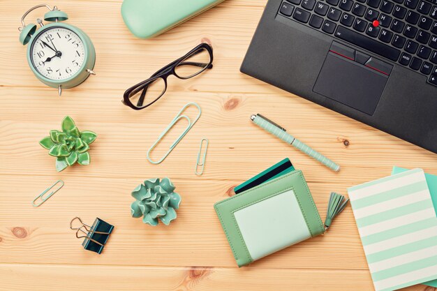 Top view over laptop and purse with credit cards