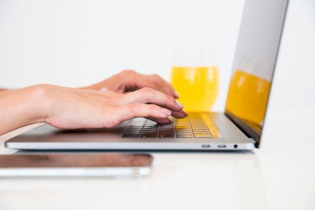 Top view laptop with orange juice