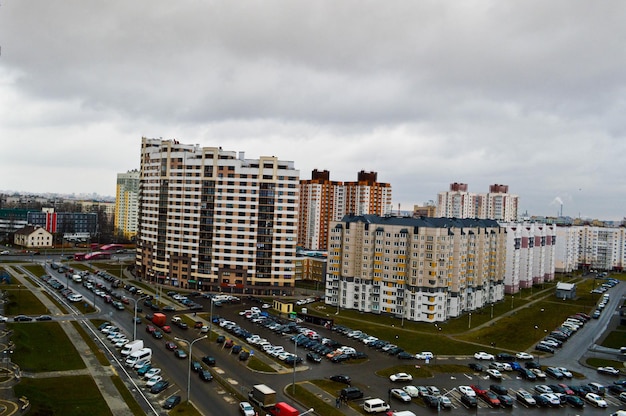 Top view of a large modern city with houses multistorey buildings and architecture parking