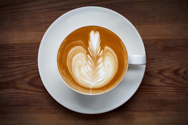 Top view latte art coffee on wood table