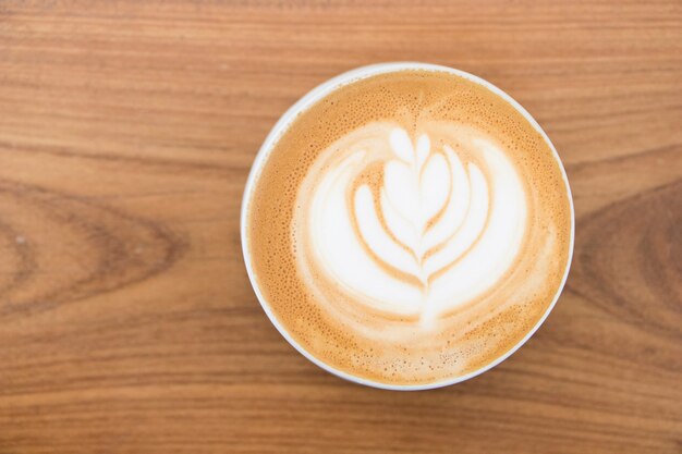 Top view latte art on wooden table