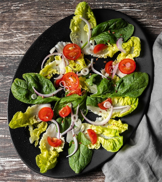 Top view leaf veggie salad and tomatoes