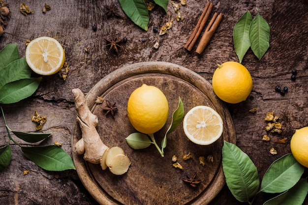 Top view lemon and ginger on cutting board