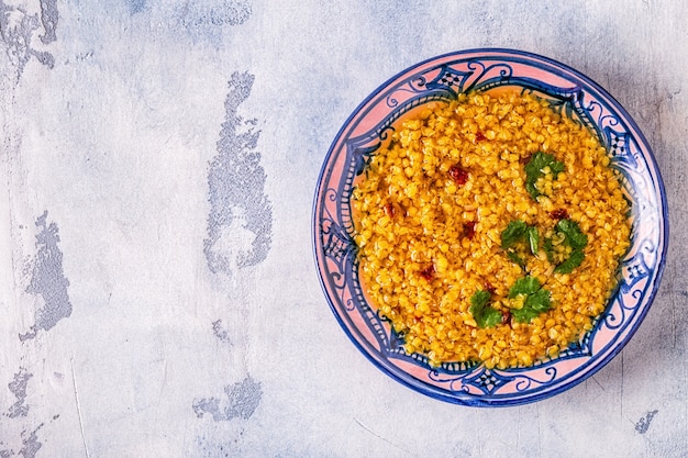 Photo top view on lentil soup served with cilantro