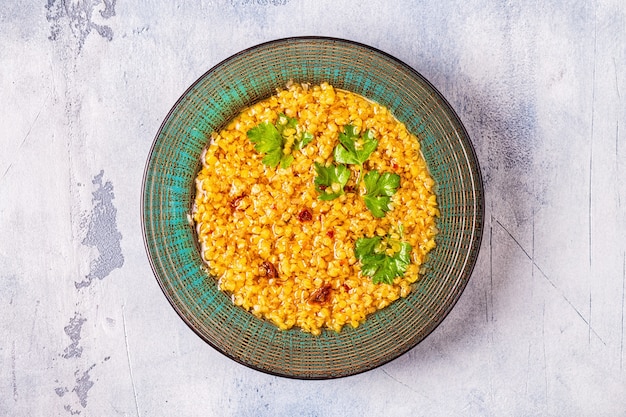 Top view on lentil soup served with cilantro