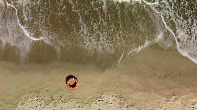 Top view of lifebuoy in the sea shore Life ring floating in a sea