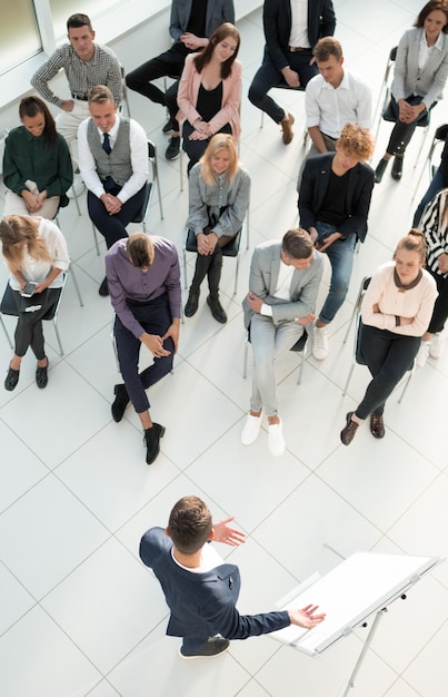 Top view listeners applauding the speaker at a business seminar