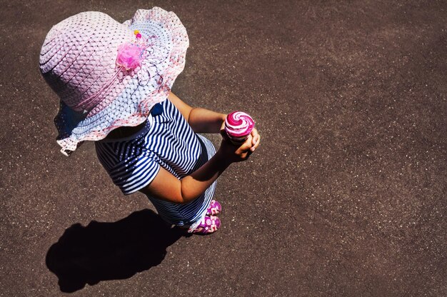 Top view of little girl eating ice cream