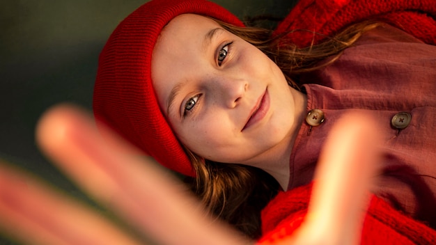 Photo top view little girl lying on a basketball field with her palm up