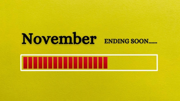 Photo top view of loading bar showing the end of november month with yellow paper background