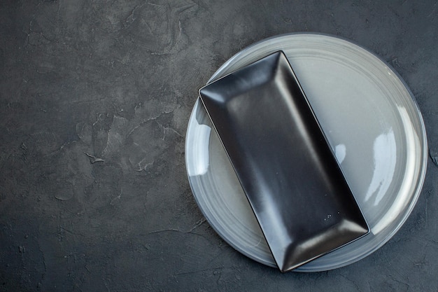 Top view long black plate in gray plate on dark background glass food colourful femininity horizontal cutlery kitchen