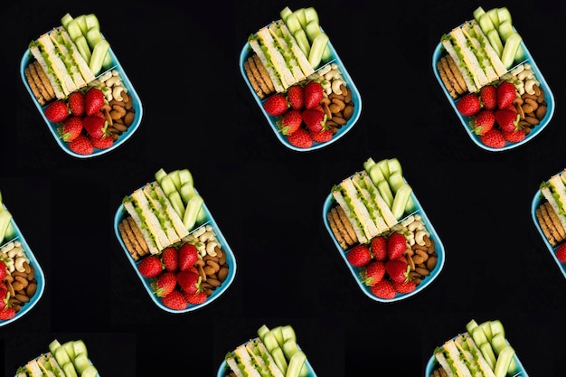 Top view of lunch box on the black background Pattern Flat lay