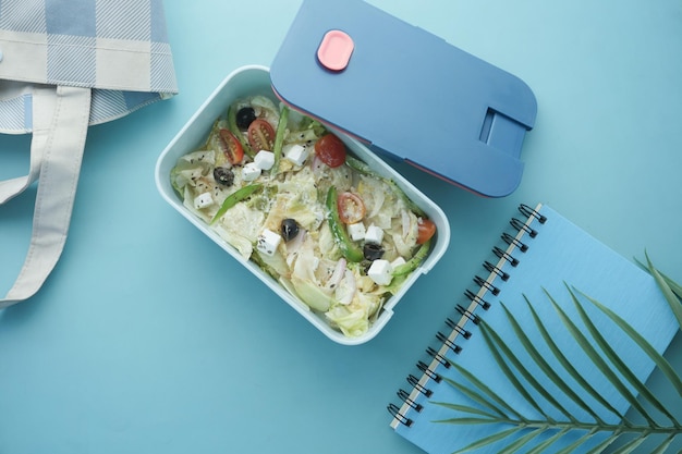 Top view of a lunch box on color background