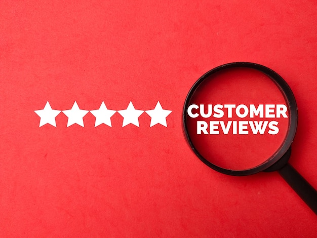 Photo top view magnifying glass with text customer reviews and star on red background