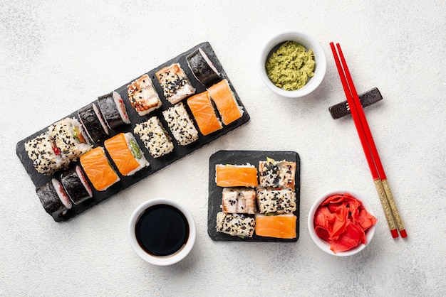 Top view maki sushi rolls assortment with chopsticks