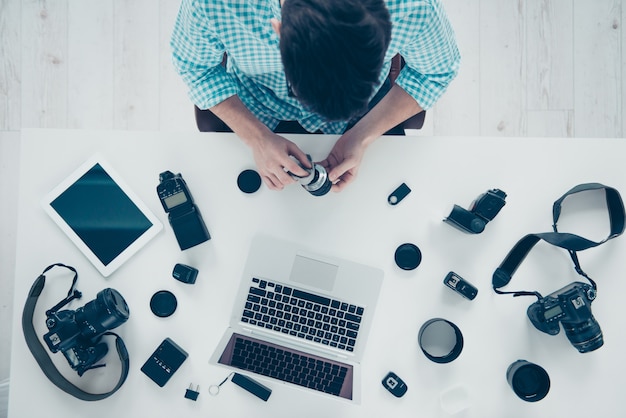 Top view of male photographer working at desk