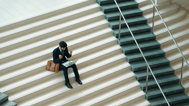 Photo top view of man celebrate successful project while using laptop exultant