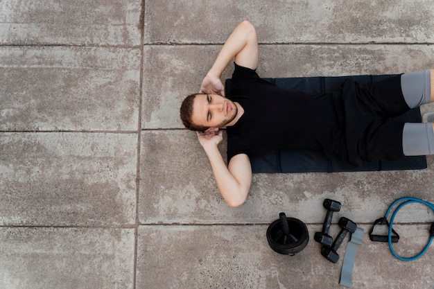 Photo top view of man doing crunches outdoors with copy space