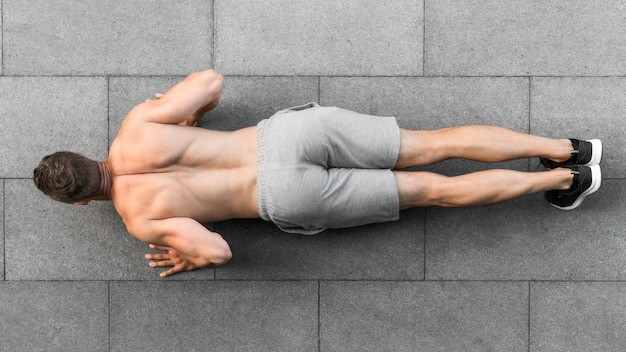 Photo top view man doing push ups