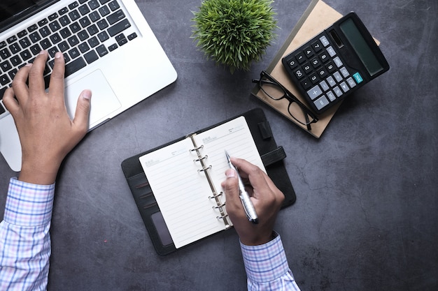 Top view of man hand typing on laptop.