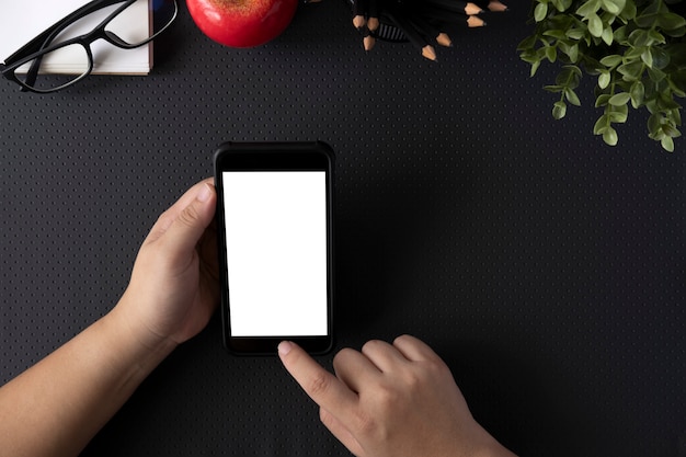 Top view of man holding blank screen smartphone. 