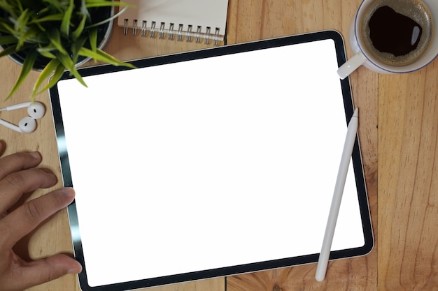 Top view man using tablet device at workspace