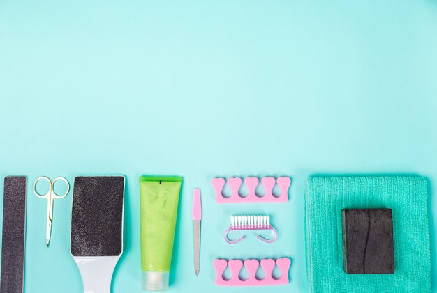 Top view of manicure and pedicure equipment on blue background. Still life. Copy space