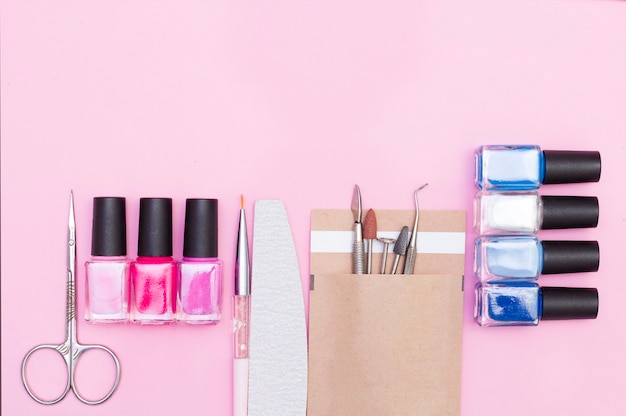 Top view of manicure, pedicure materials, on a pink\
background