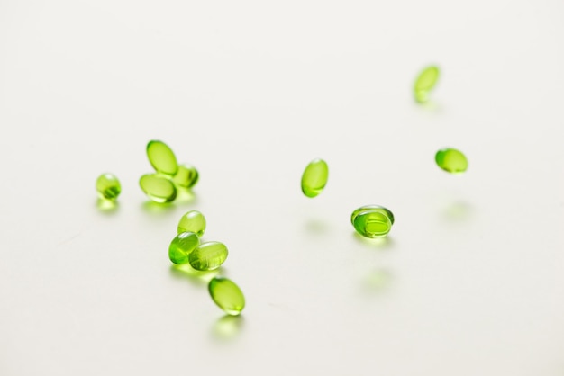 Top view many gel capsules on white background isolated. Vitamin E 200 mg capsules.