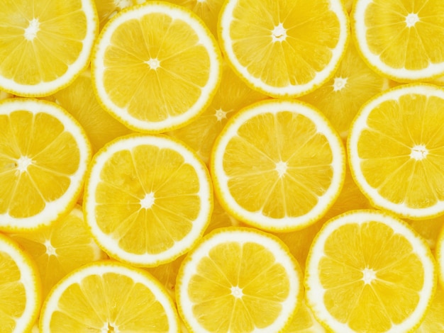 La vista superiore di molti pezzi di disposizione affettata della frutta del limone da modellare priorità bassa del reticolo.