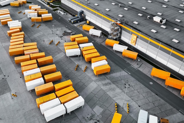 Top view of many trailers and containers near the logistics\
warehouse in the evening