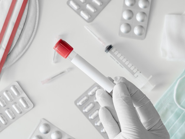 top view of Medical Concept with syringe, Medical Mask, medicine and test tube on white table background