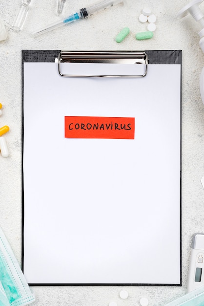 Top view medical desk composition with coronavirus tag