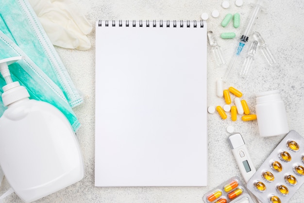 Photo top view medical objects arrangement with empty notepad