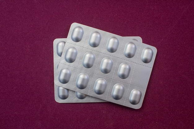 Top view of medical pills on color background